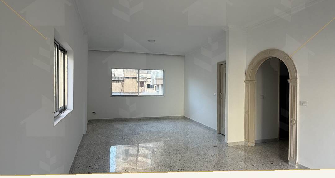 Reception with terrazzo flooring and an arched opening to the hall, apartment for rent in Verdun, Beirut — Ref. W1167