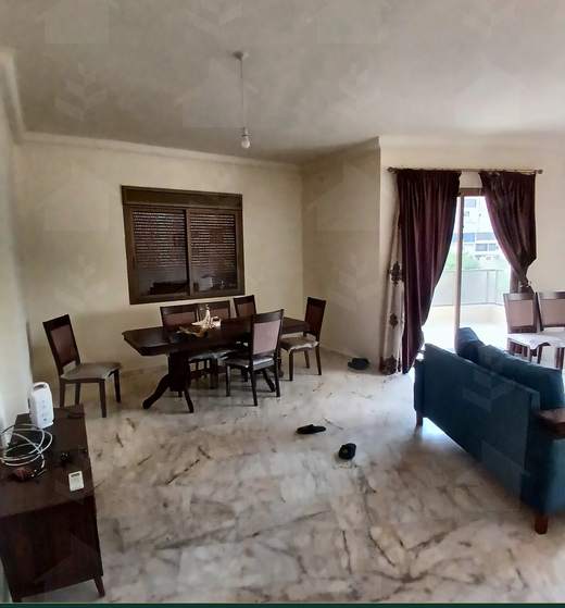 Living and dining areas side by side under an arched opening, furnished apartment for sale in Hay El Amerkan, Hadath — Ref. 1197