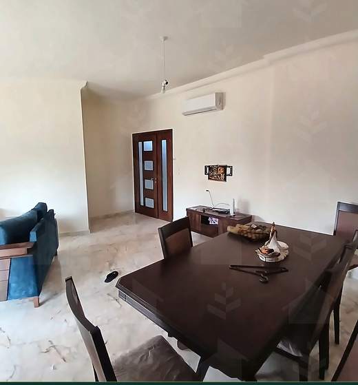 Dining room with a dark wood table and six chairs, furnished apartment for sale in Hay El Amerkan, Hadath — Ref. 1197