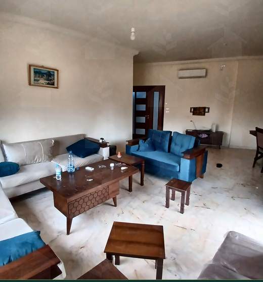 Second sitting area with armchairs and a low table, furnished apartment for sale in Hay El Amerkan, Hadath — Ref. 1197