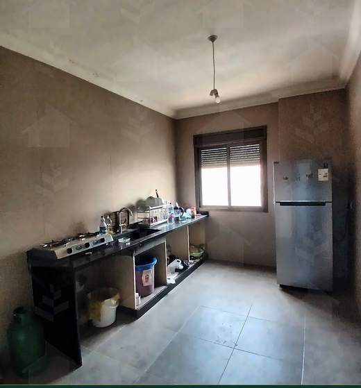 Kitchen with a run of counter units, fridge and a window over the garden, furnished apartment for sale in Hay El Amerkan, Hadath — Ref. 1197