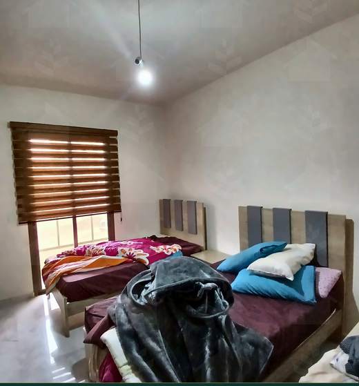 Bedroom with an upholstered headboard and a shuttered window, furnished apartment for sale in Hay El Amerkan, Hadath — Ref. 1197