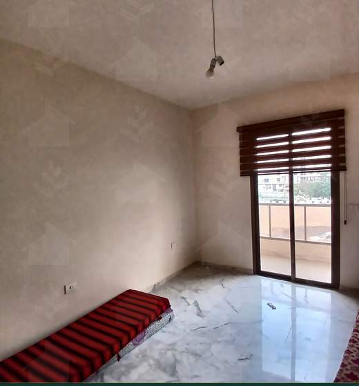 Third room, unfurnished, with a balcony door and a window to the garden, furnished apartment for sale in Hay El Amerkan, Hadath — Ref. 1197