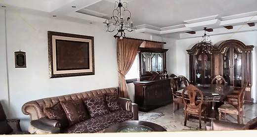 Reception with upholstered seating, chandelier and carved wood display cabinet, apartment for sale on Tariq Al Matar, Haret Hreik — Ref. 1198