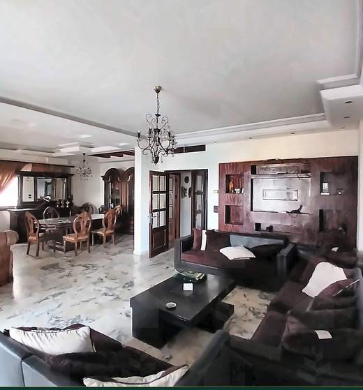 Salon from the second angle, with seating and a wall unit, apartment for sale on Tariq Al Matar, Haret Hreik — Ref. 1198