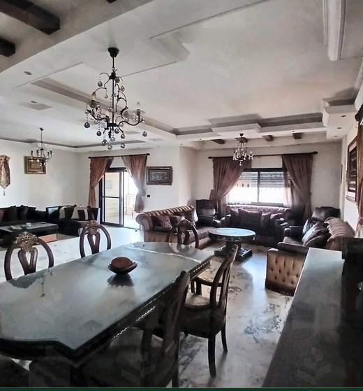 Dining room with a long table, carved chairs and chandelier, apartment for sale on Tariq Al Matar, Haret Hreik — Ref. 1198