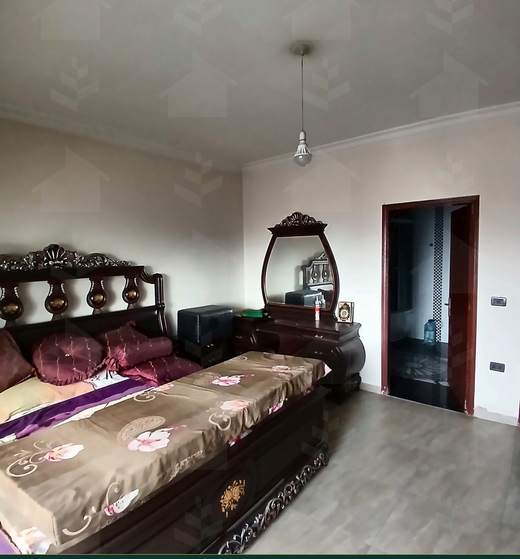 Master bedroom with a carved wooden bed and dressing table, apartment for sale on Tariq Al Matar, Haret Hreik — Ref. 1198